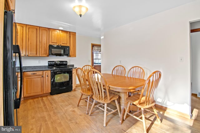 kitchen featuring black appliances and light hardwood / wood-style floors