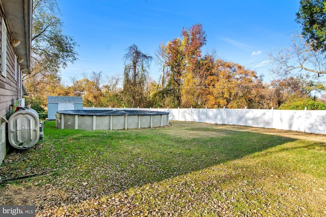 view of yard with a covered pool