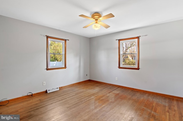 unfurnished room with ceiling fan, a healthy amount of sunlight, and light hardwood / wood-style floors