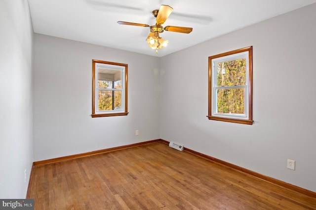 spare room with ceiling fan and wood-type flooring