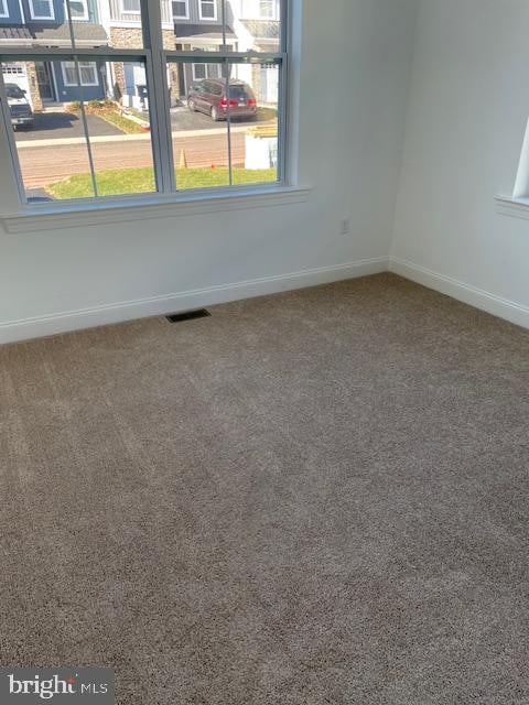 unfurnished room featuring carpet