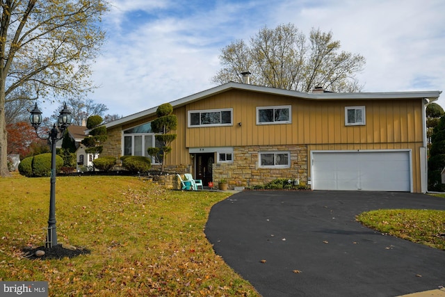 view of front of house with a front yard and a garage