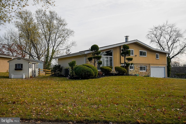 view of front of home with a front yard and a garage