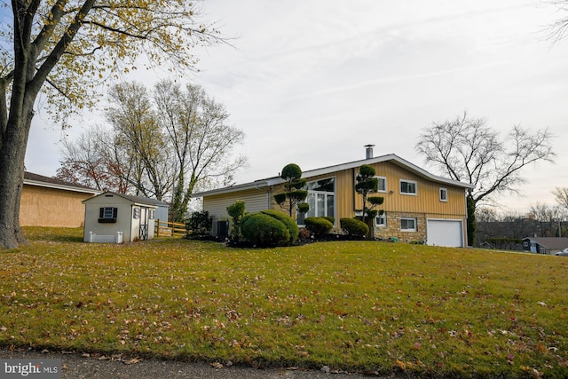 view of front facade with a garage and a front lawn