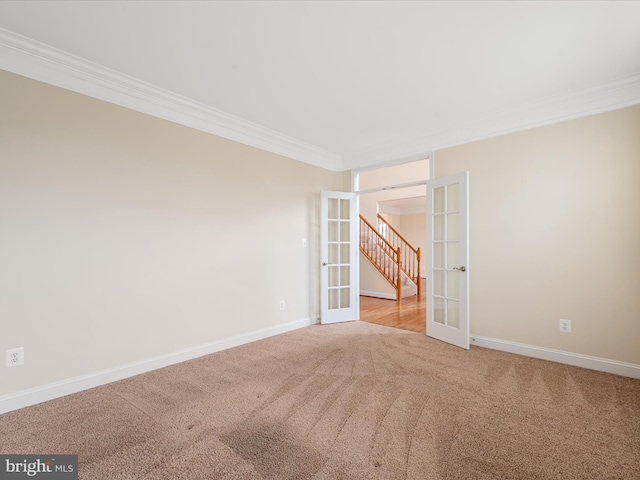 spare room with carpet flooring, french doors, and ornamental molding