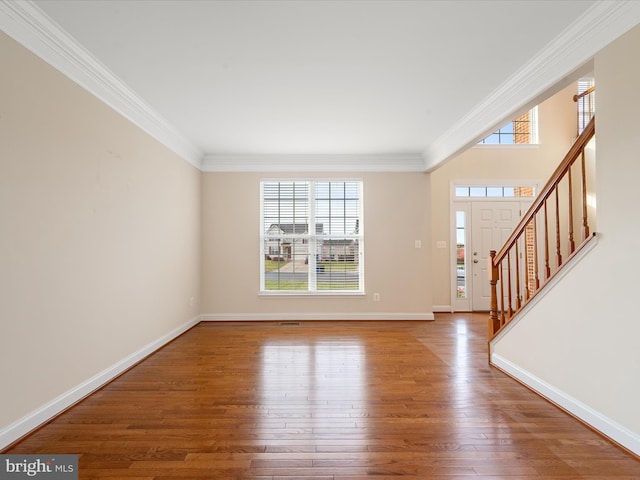 foyer featuring crown molding and wood-type flooring