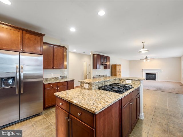 kitchen featuring black gas stovetop, light colored carpet, ceiling fan, stainless steel fridge with ice dispenser, and hanging light fixtures