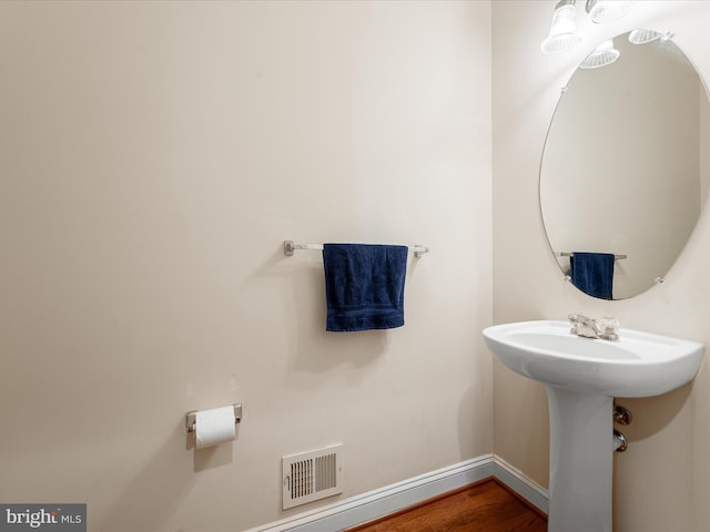 bathroom featuring sink and hardwood / wood-style flooring