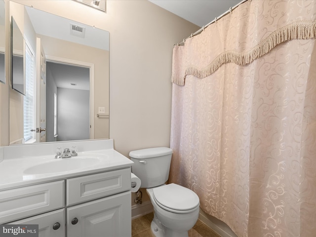 bathroom featuring curtained shower, tile patterned flooring, vanity, and toilet