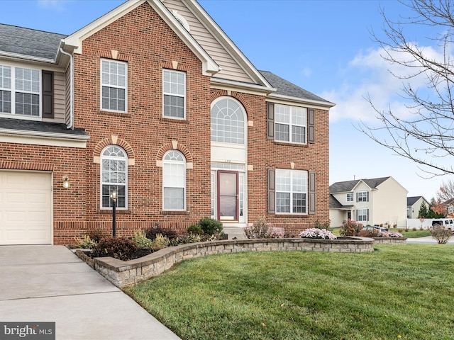 view of front of property with a front yard and a garage