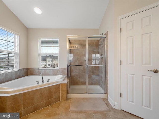 bathroom featuring tile patterned floors, separate shower and tub, and vaulted ceiling