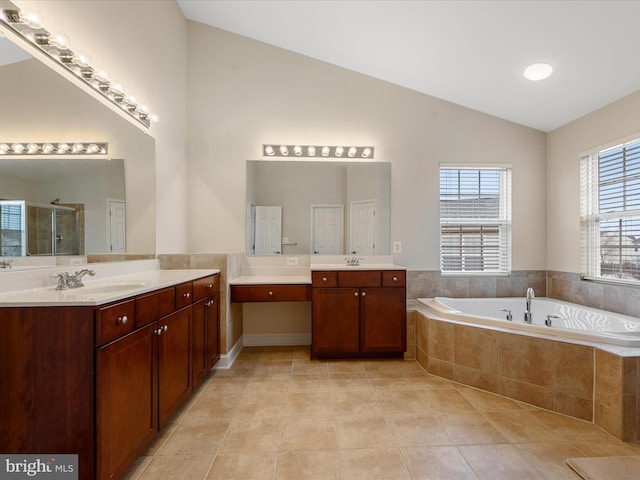 bathroom featuring tile patterned flooring, vanity, independent shower and bath, and lofted ceiling