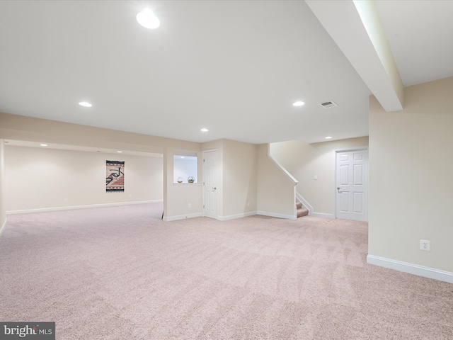 basement featuring light carpet