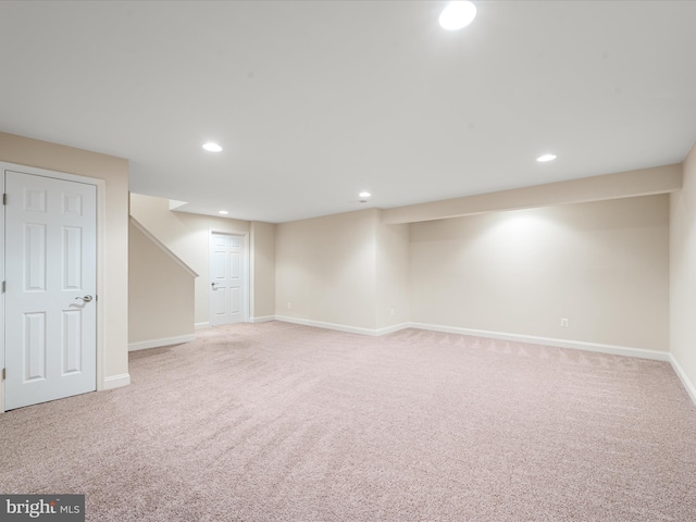 basement featuring light carpet