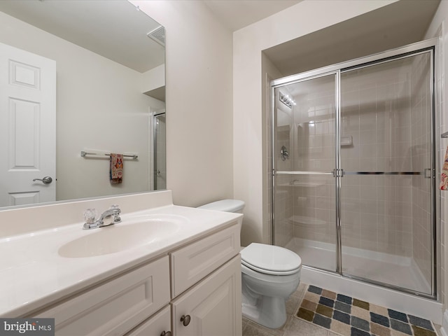 bathroom with walk in shower, tile patterned flooring, vanity, and toilet