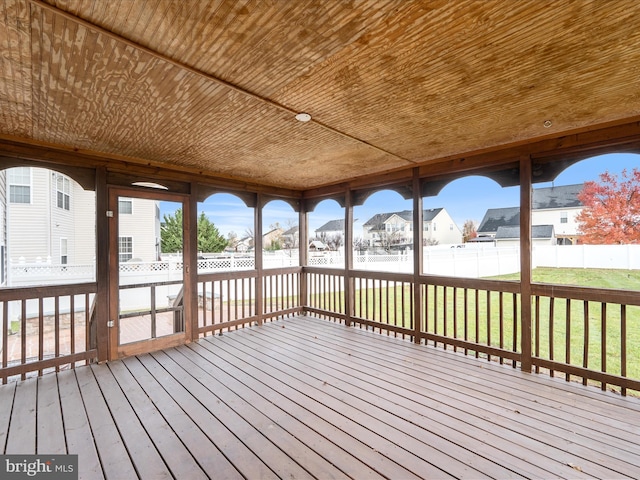 wooden terrace featuring a yard