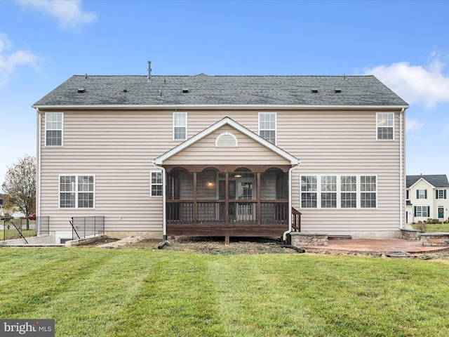 rear view of property with a patio area, a sunroom, and a yard