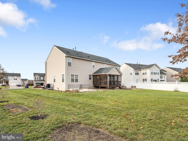 rear view of house featuring a sunroom, a yard, and central AC unit