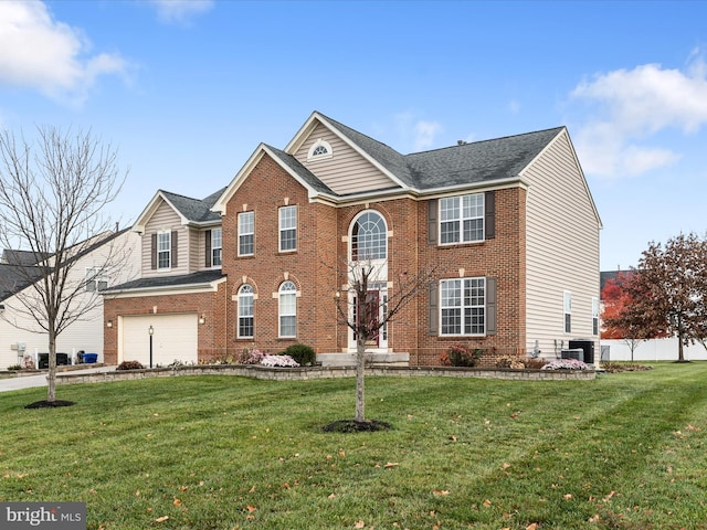 view of front of property with a front yard, a garage, and central AC unit