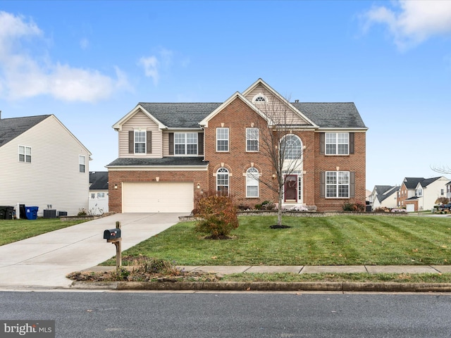 view of front of house with a front yard, central AC, and a garage