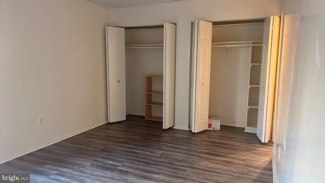 unfurnished bedroom featuring dark hardwood / wood-style flooring