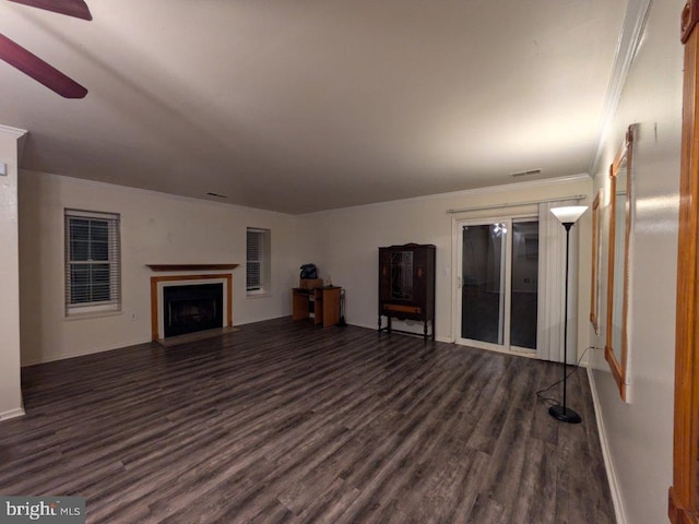 unfurnished living room featuring crown molding, dark hardwood / wood-style flooring, and ceiling fan