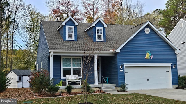 cape cod-style house with a shed and a garage