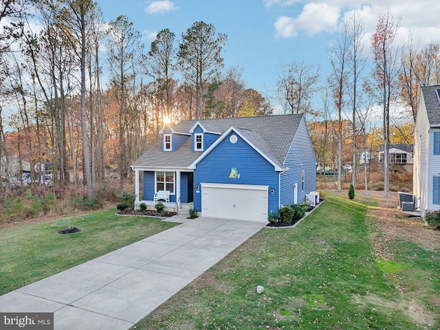 view of front of home featuring central AC, a garage, and a front lawn