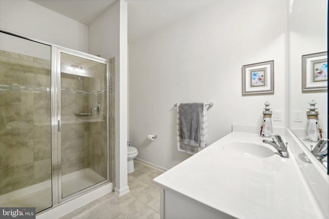 bathroom with vanity, a shower with shower door, and toilet