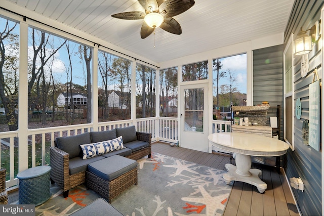 sunroom / solarium featuring ceiling fan