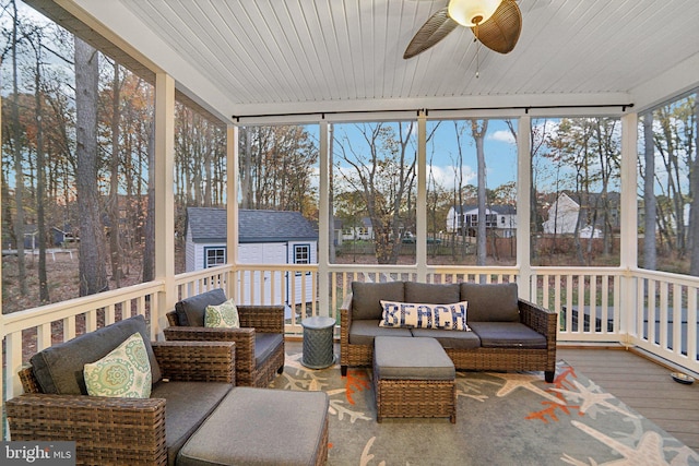 sunroom with ceiling fan and wooden ceiling