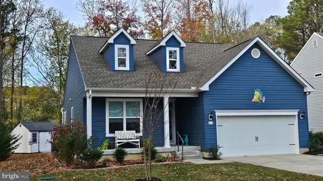 cape cod home with a shed and a garage