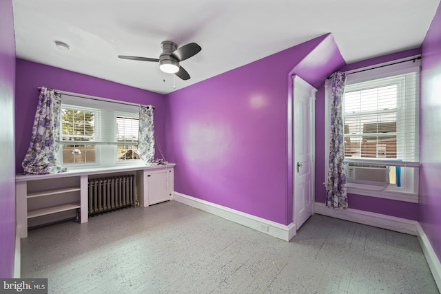 interior space featuring multiple windows, radiator, and ceiling fan