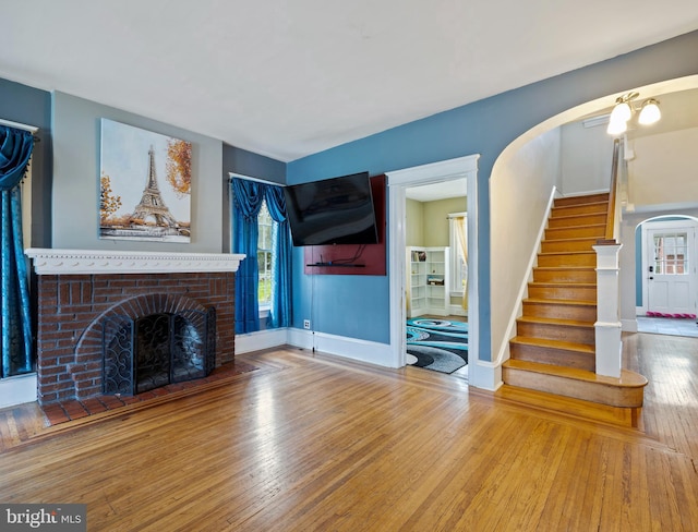 unfurnished living room featuring a fireplace and wood-type flooring