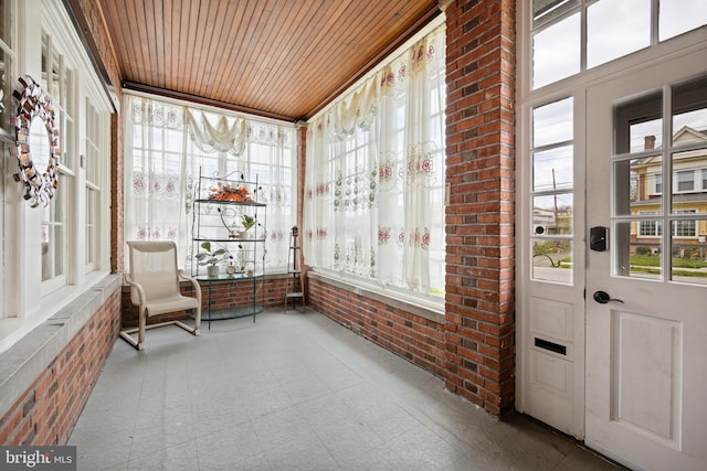 sunroom with wooden ceiling and a healthy amount of sunlight