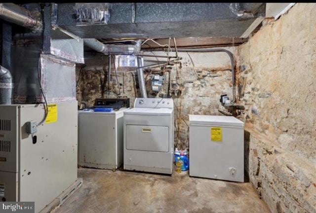 washroom featuring washer and dryer and heating unit