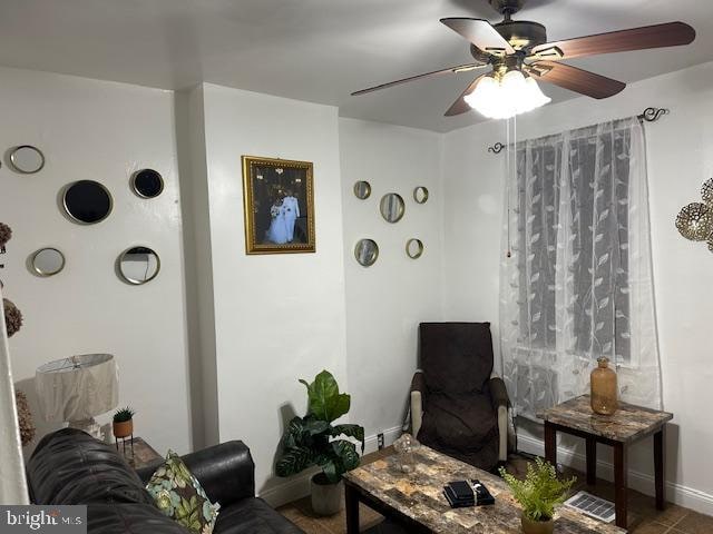 living room with tile patterned flooring and ceiling fan