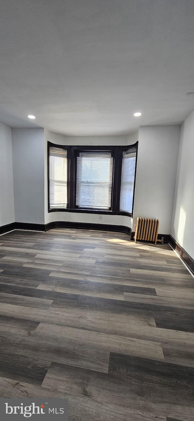 empty room with dark wood-type flooring