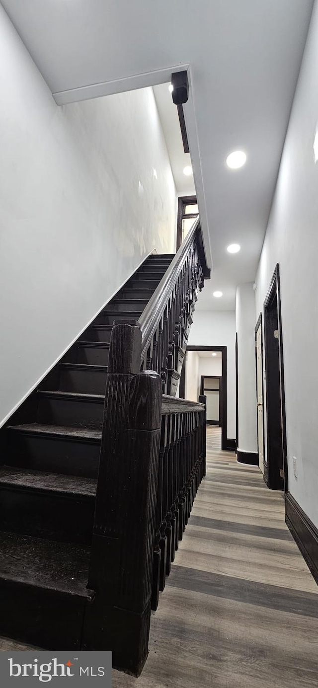 stairway featuring wood-type flooring