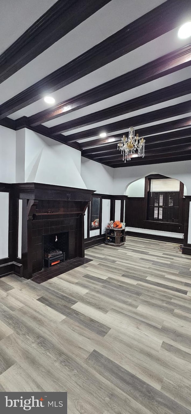 interior space featuring beamed ceiling and hardwood / wood-style floors