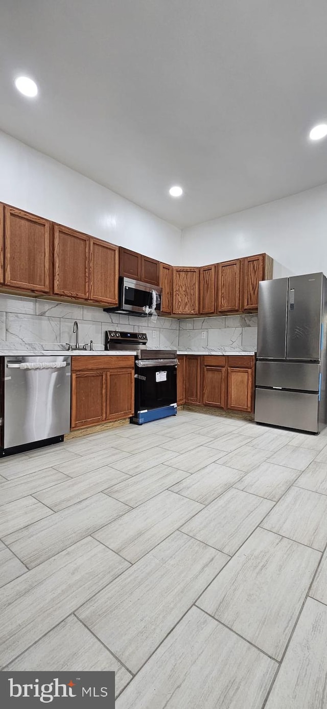 kitchen with backsplash and appliances with stainless steel finishes