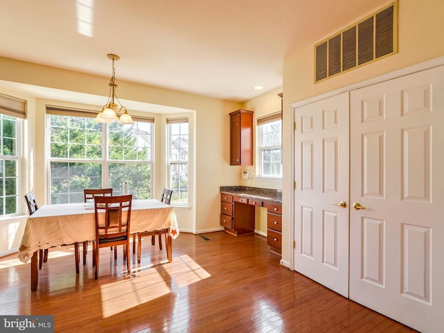 dining space featuring hardwood / wood-style flooring and a healthy amount of sunlight