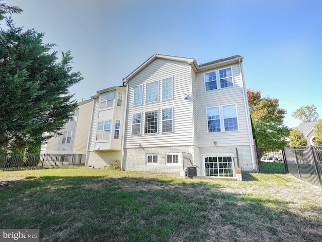 back of property featuring a lawn and central AC unit