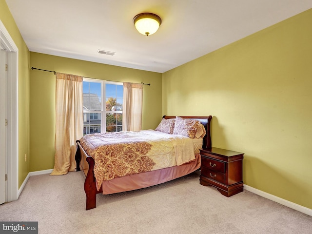 bedroom featuring light carpet