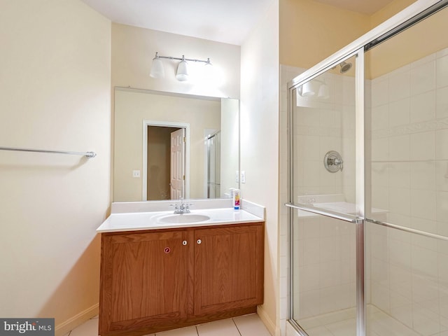 bathroom featuring vanity, tile patterned floors, and a shower with door