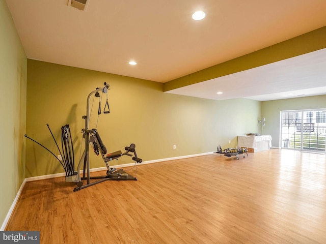 workout room with light hardwood / wood-style flooring