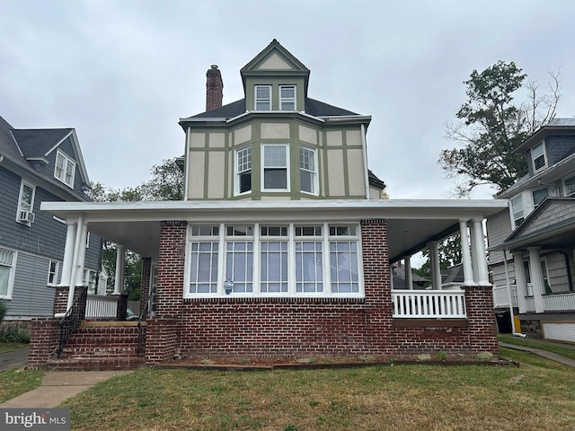 view of home's exterior with a lawn and covered porch