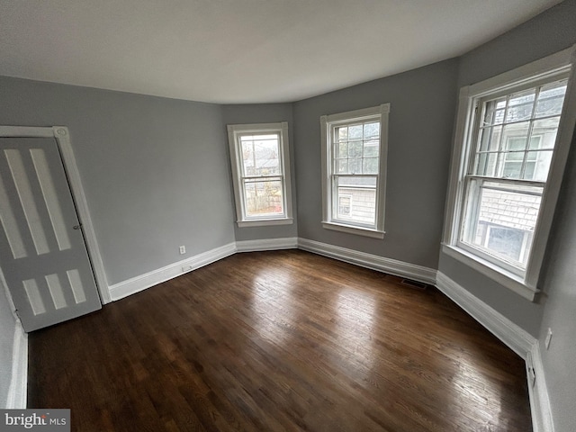 unfurnished room featuring dark hardwood / wood-style flooring