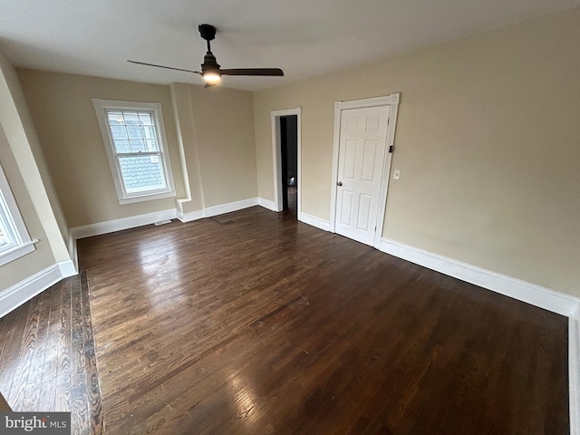 unfurnished room with ceiling fan and dark hardwood / wood-style floors