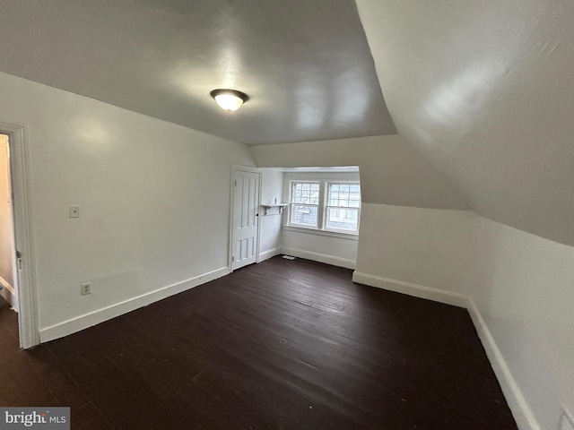 bonus room featuring lofted ceiling and dark hardwood / wood-style floors